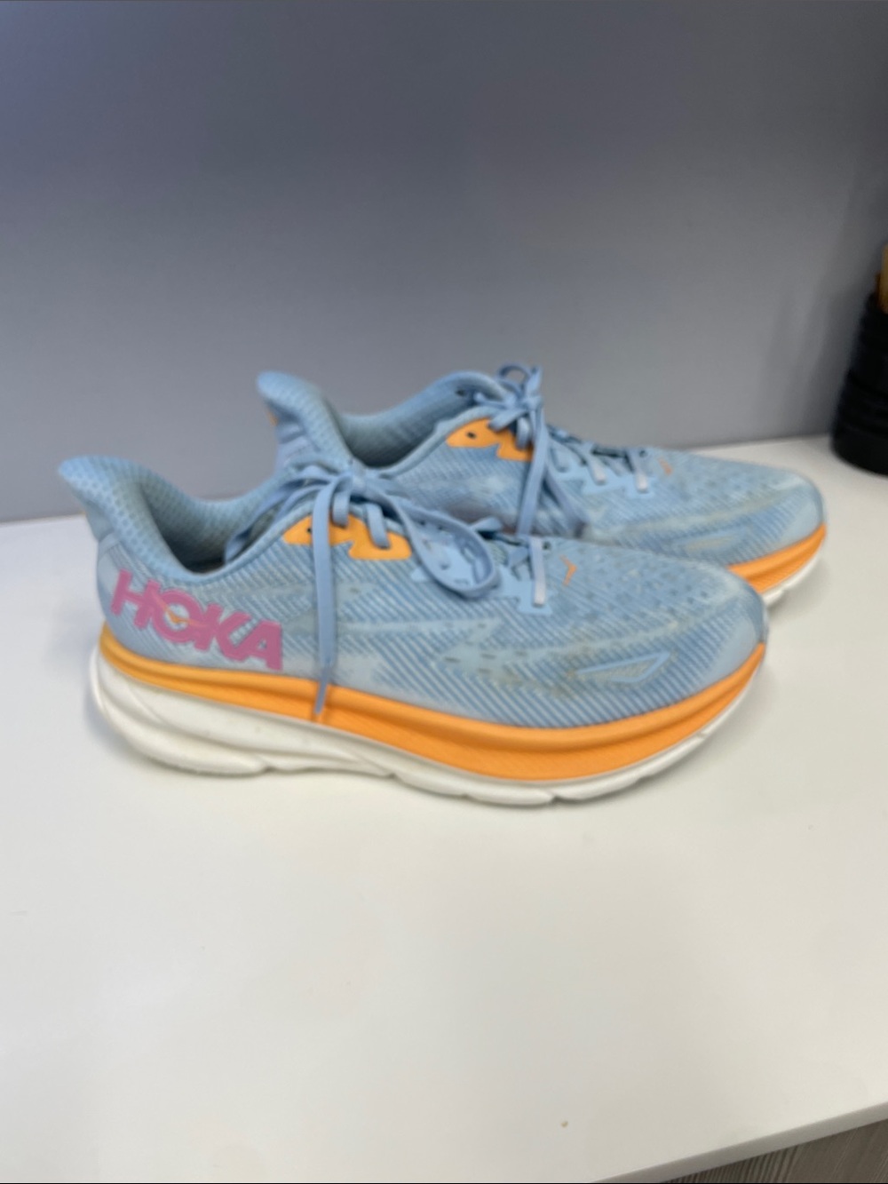 HOKA CLIFTON9.  Woman’s. Light Blue Sneakers with Orange Accents Sz 9.
